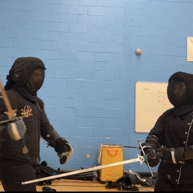 Olgun Tiltay learning Longsword movement from Cosmas Cieplak-Mayr von Baldegg HEMA instructor in Ausardia
